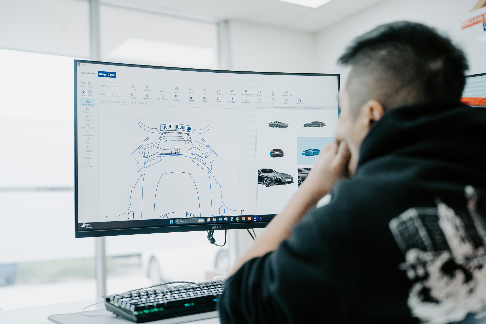 Liquid R technician plotting a precut paint protection film pattern on screen