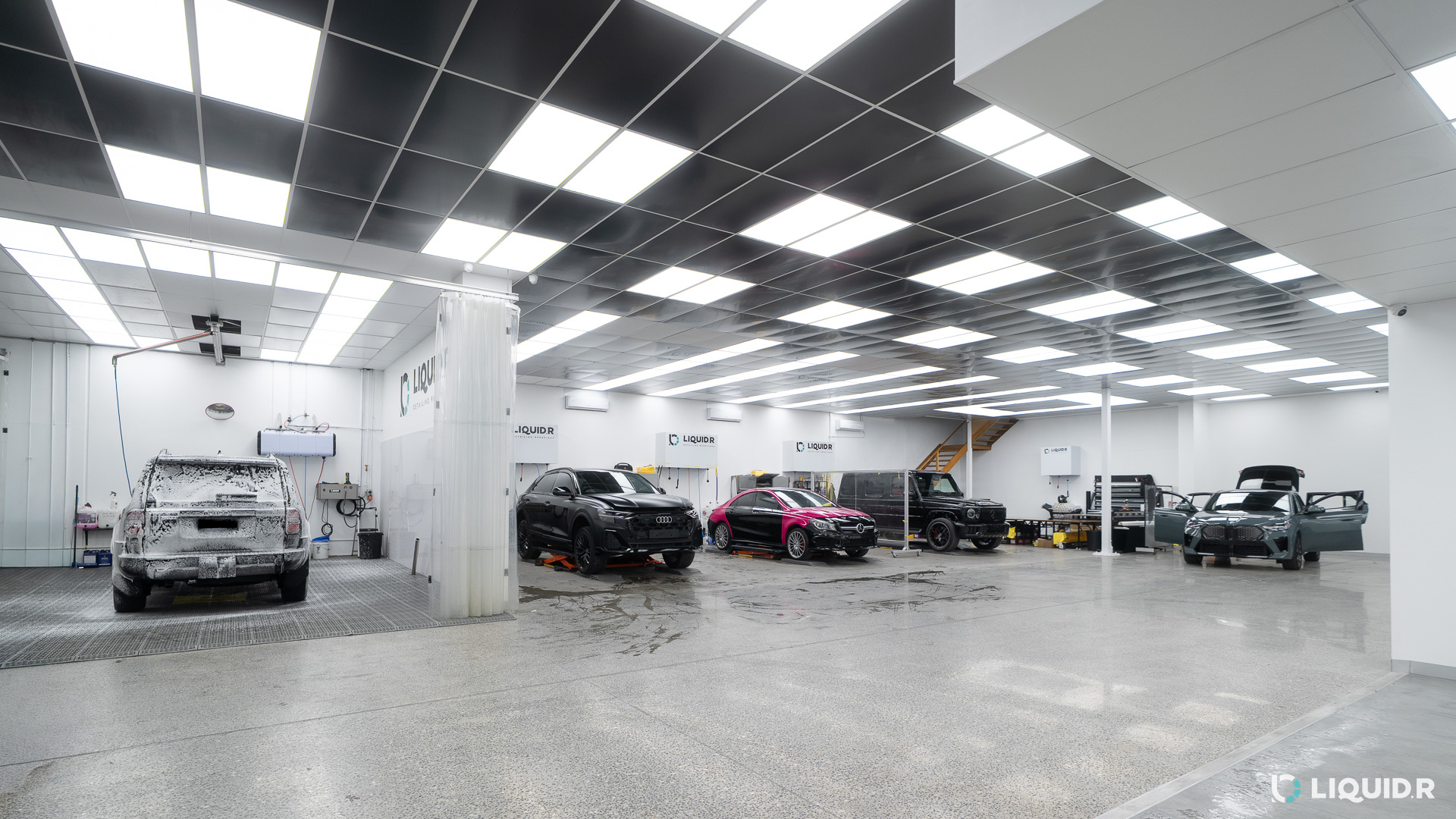Inside the Liquid R workshop in Mitcham with several cars in for protection work