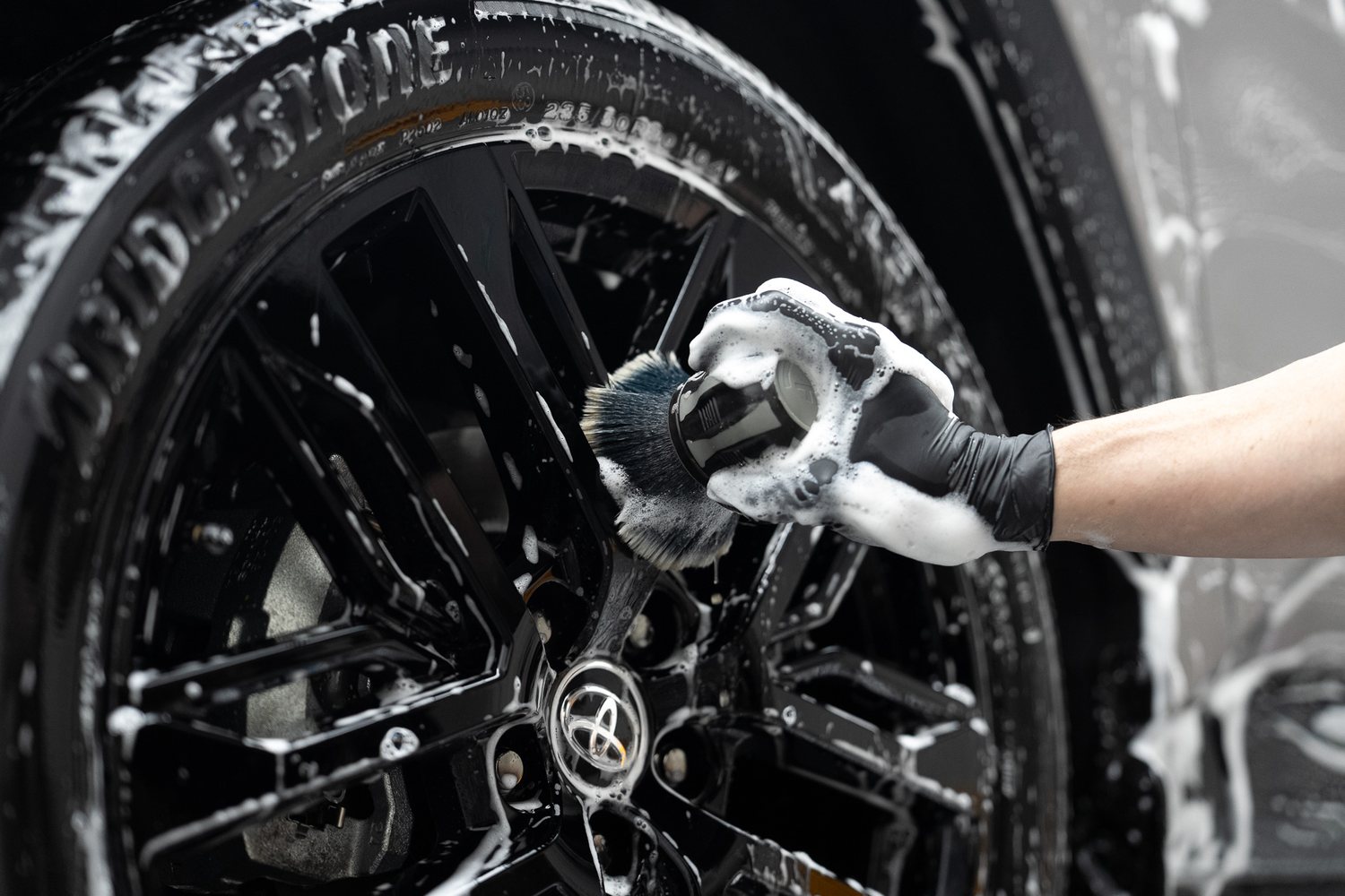 Brush cleaning a wheel and tyre