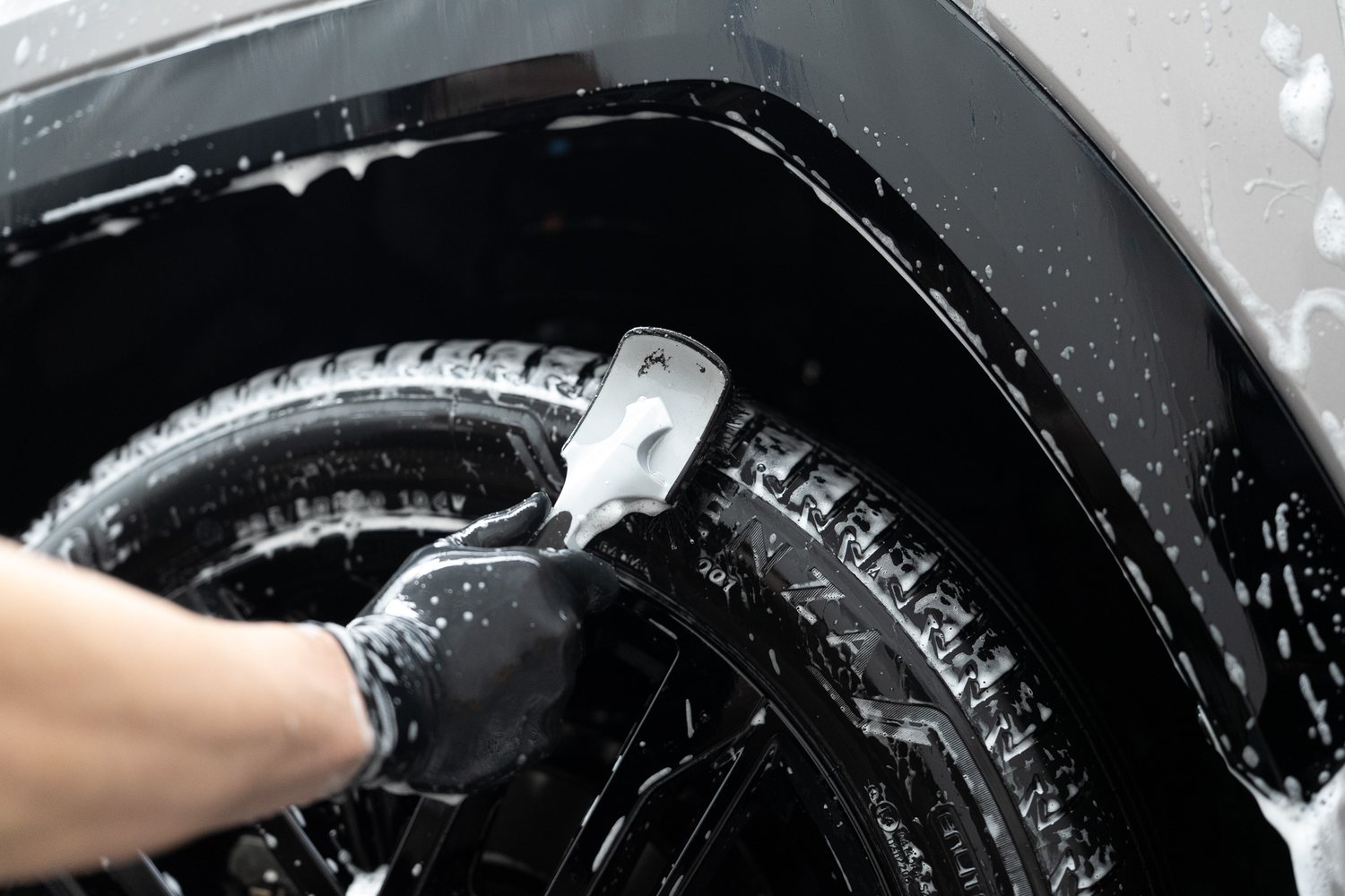 Brush cleaning a wheel and tyre