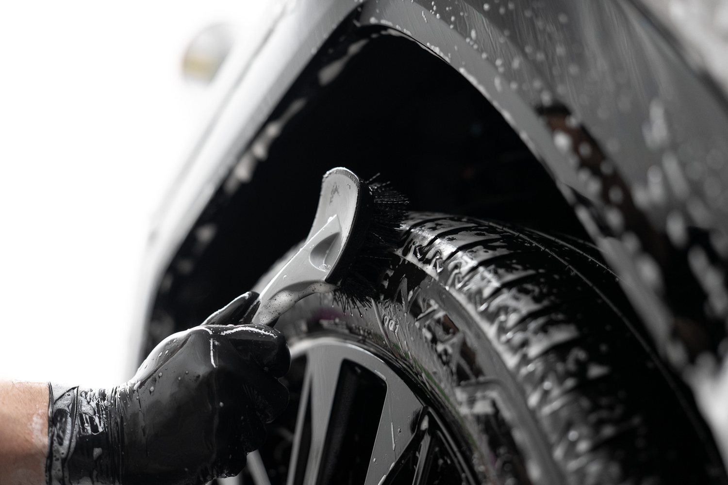 Brush cleaning a wheel and tyre