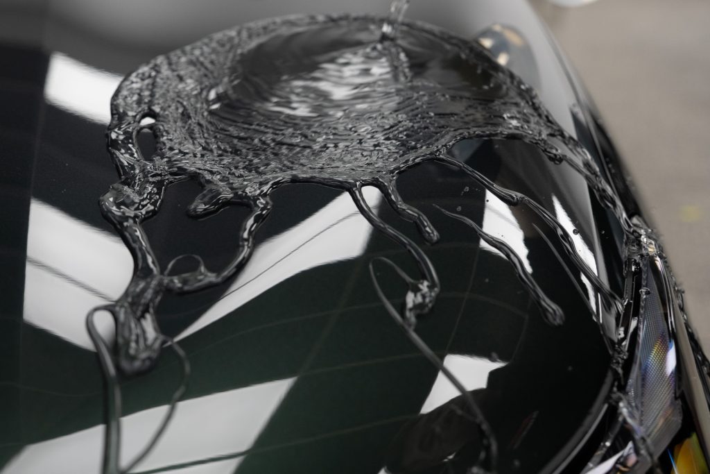 Water beading on a freshly ceramic coated black bonnet