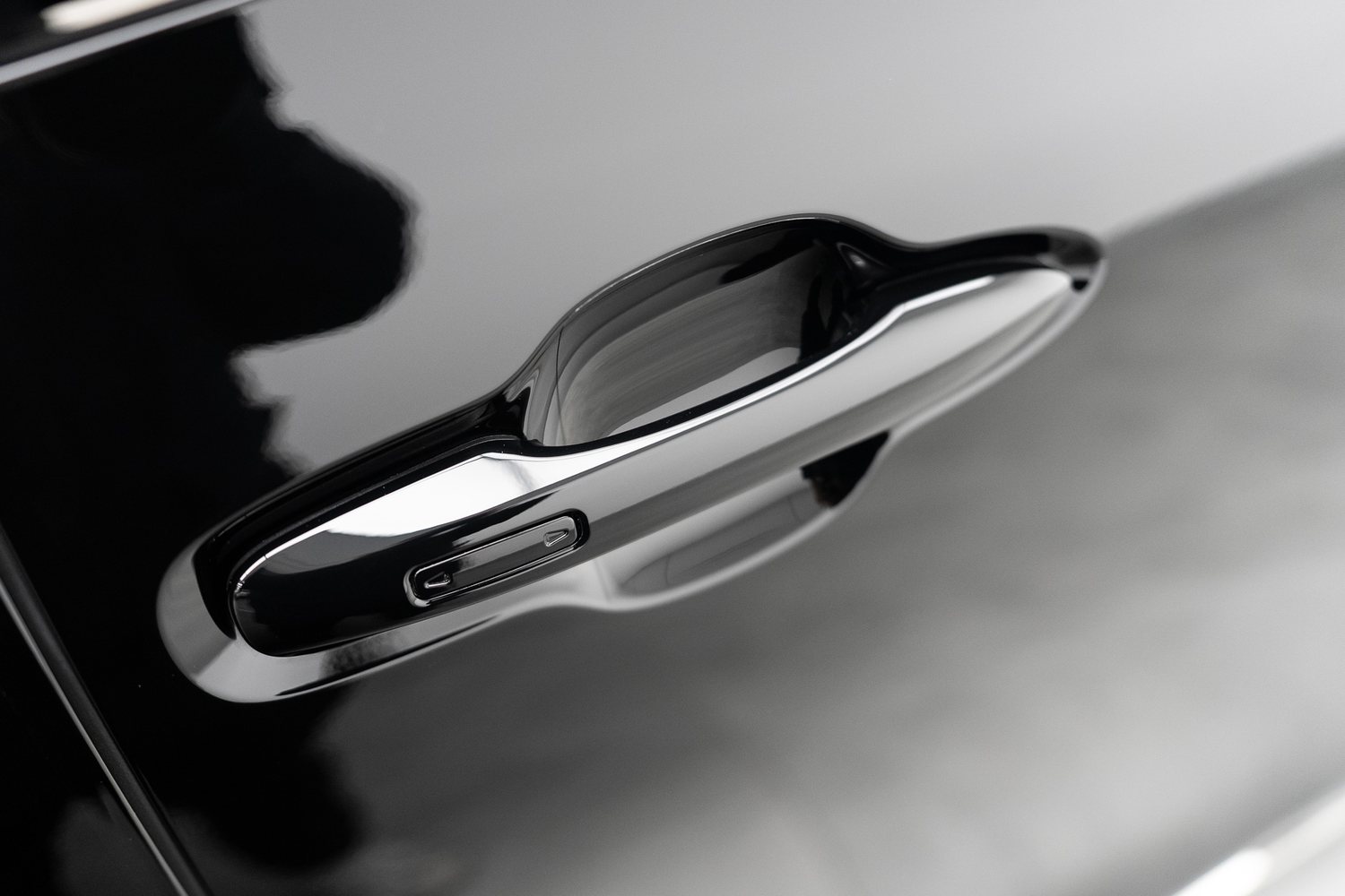 Chrome door handle on a satin black car