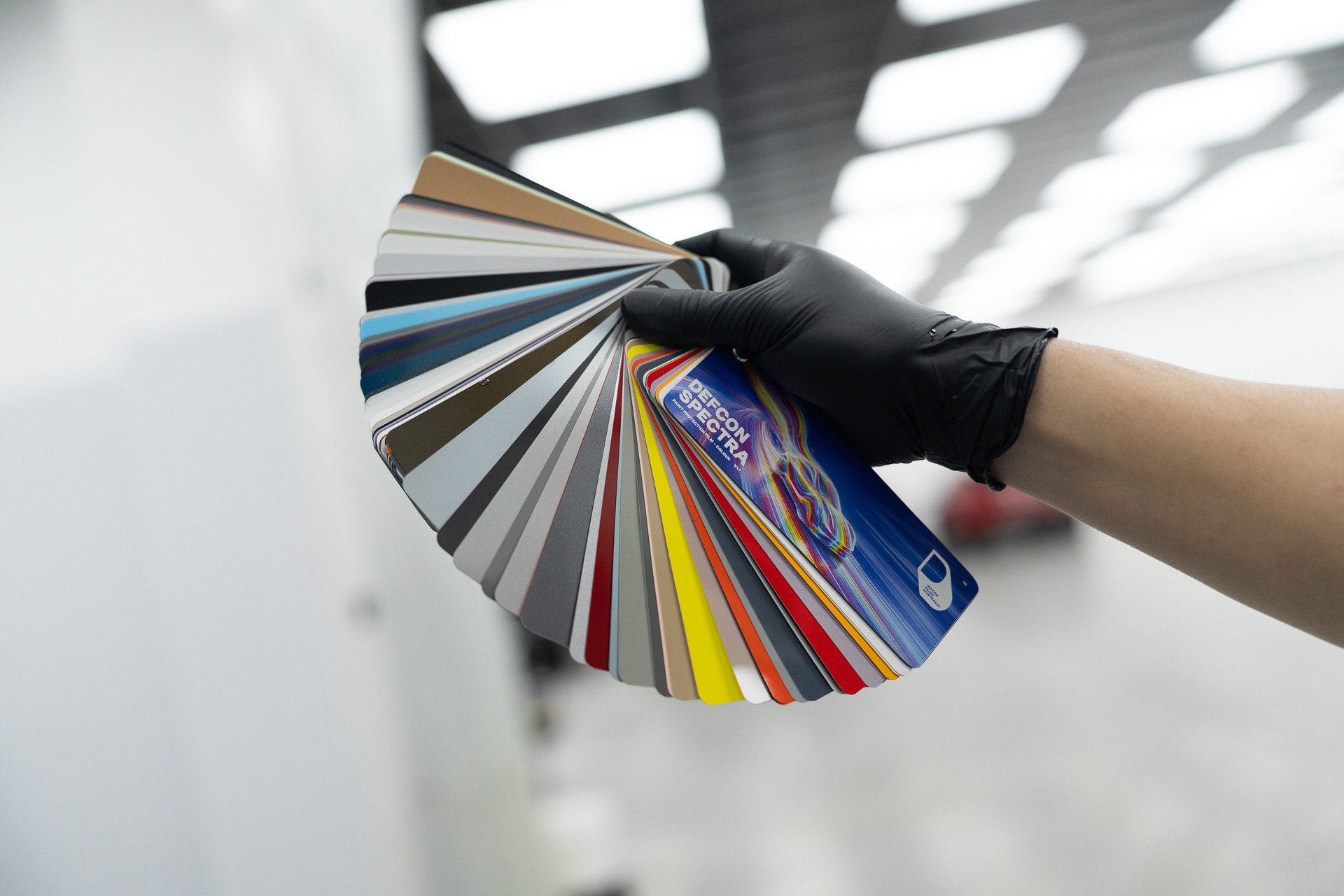Colour film swatch fan held up in the Liquid R workshop