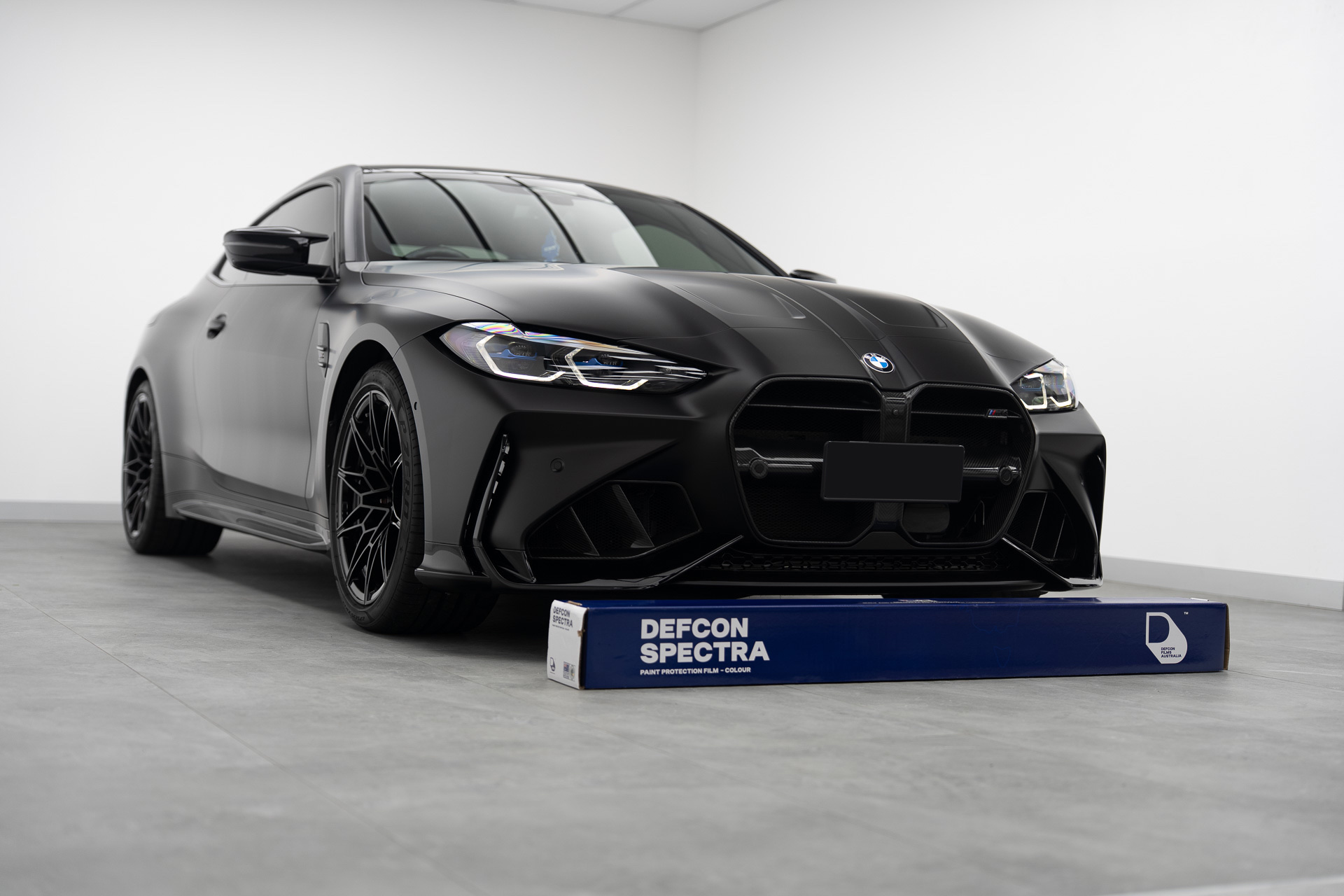 Satin black BMW M4 with a Defcon Spectra colour PPF roll
