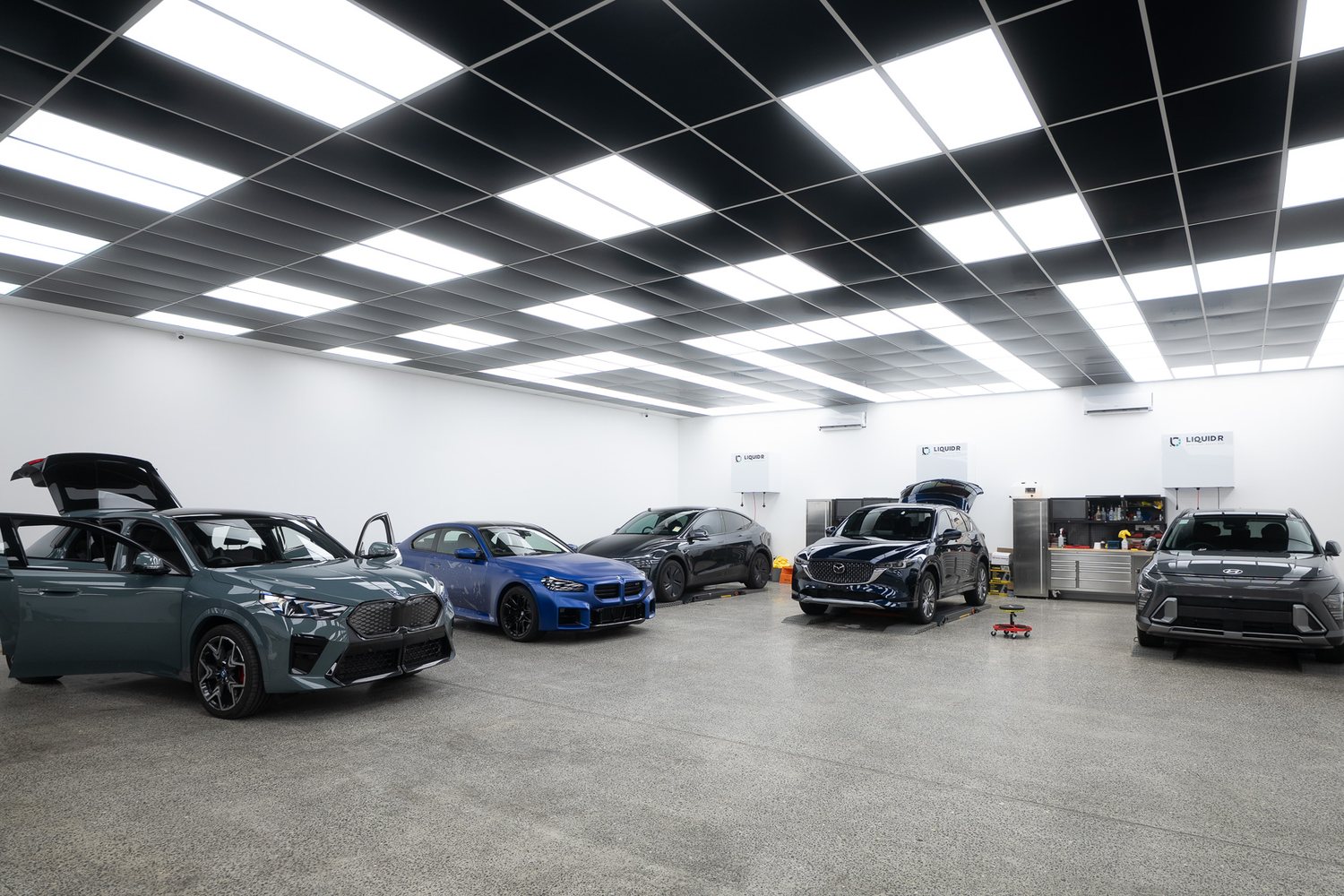 Customer cars in the Liquid R workshop