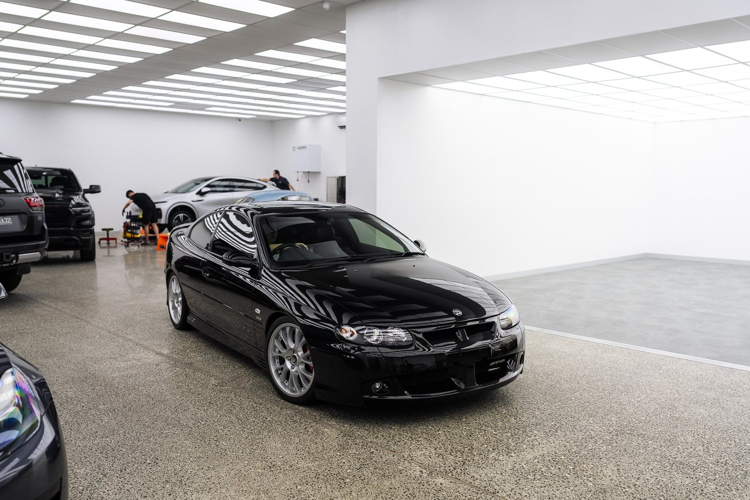 Customer cars in the Liquid R workshop