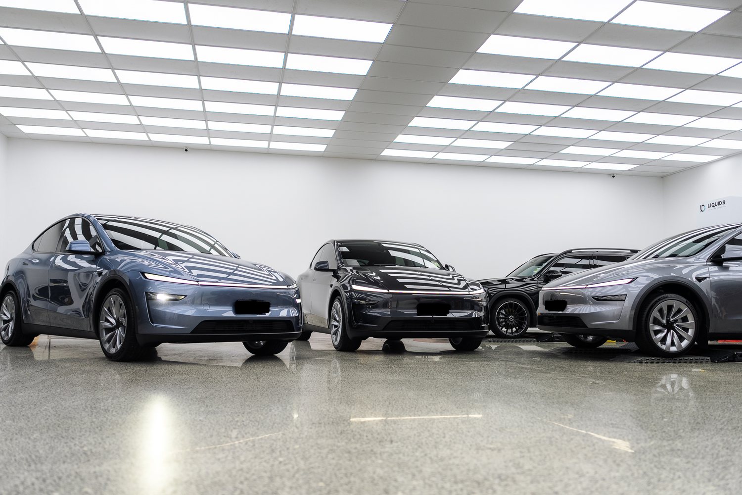 Customer cars in the Liquid R workshop