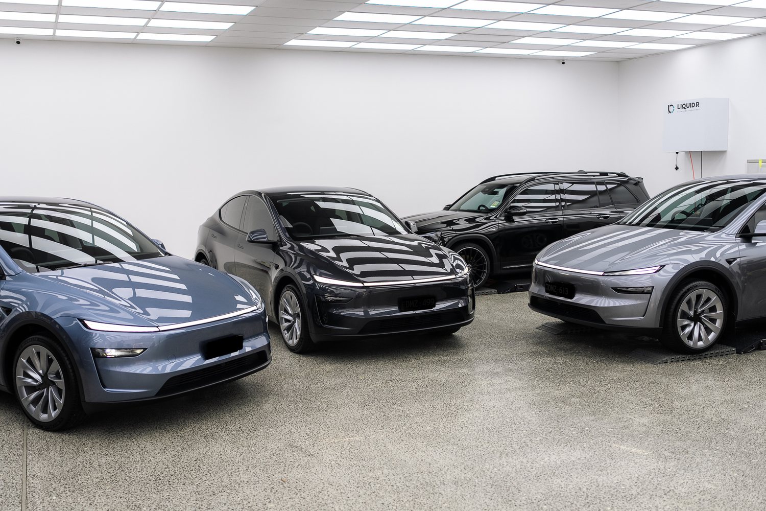 Customer cars in the Liquid R workshop