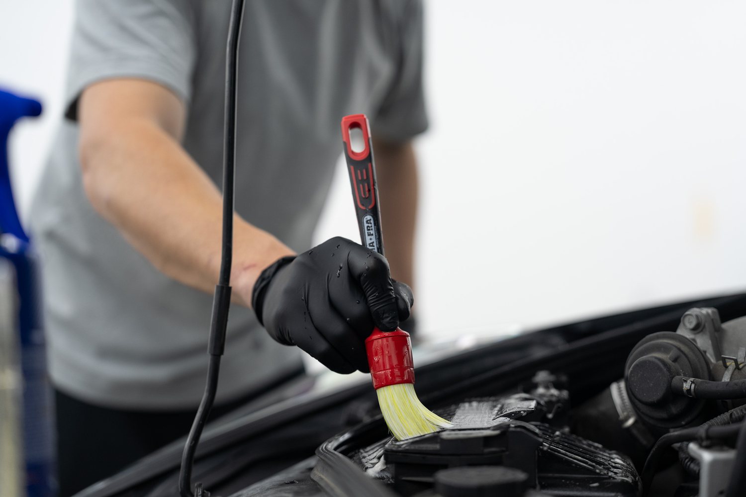 Detailing brush cleaning an engine bay