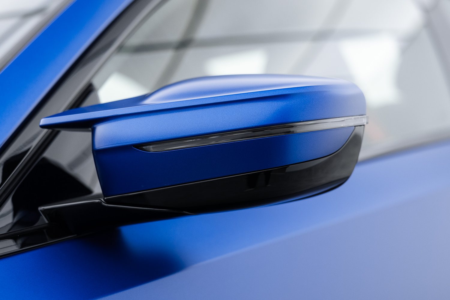 Door and mirror detail on a blue BMW M2