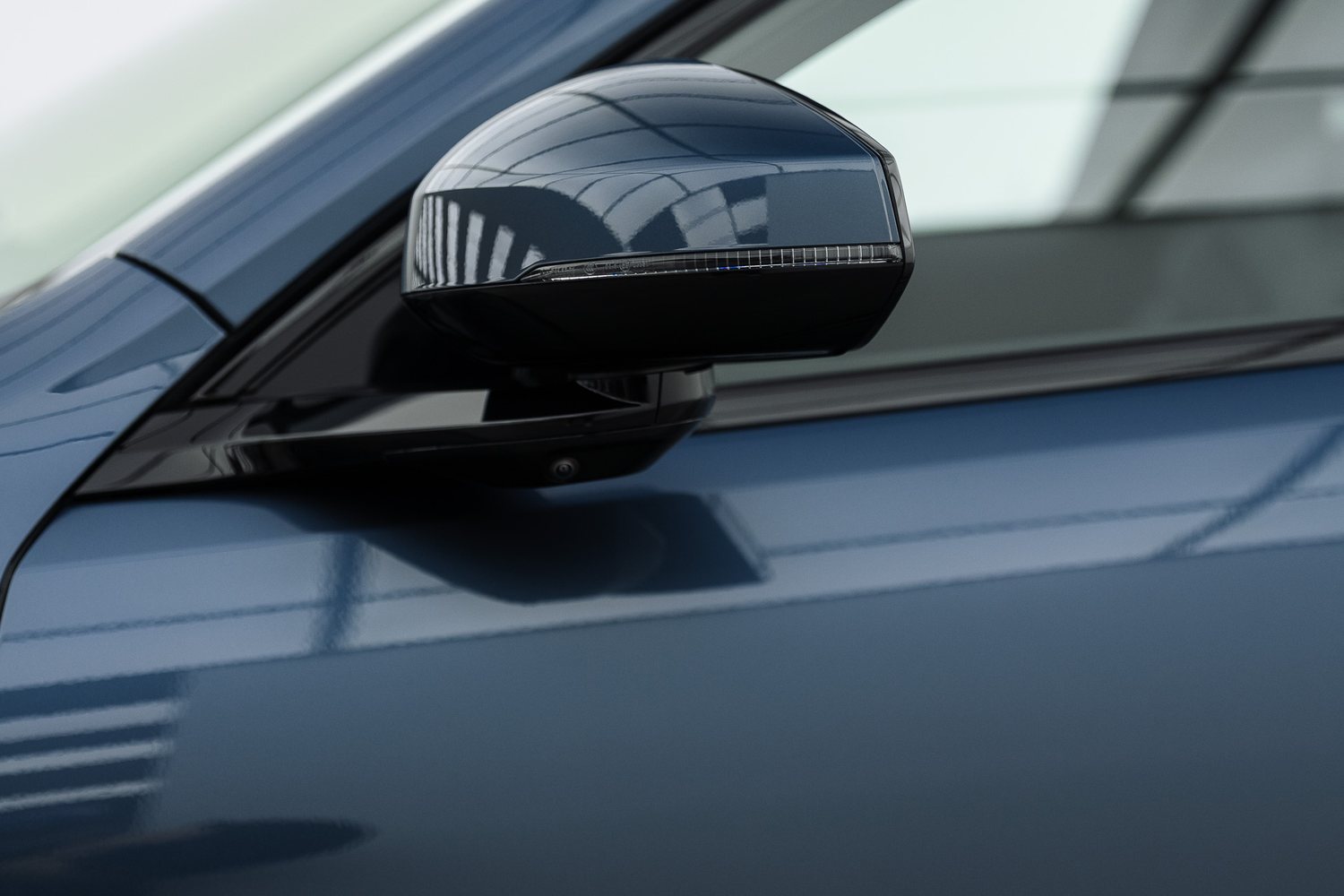 Door and mirror detail on a blue Polestar