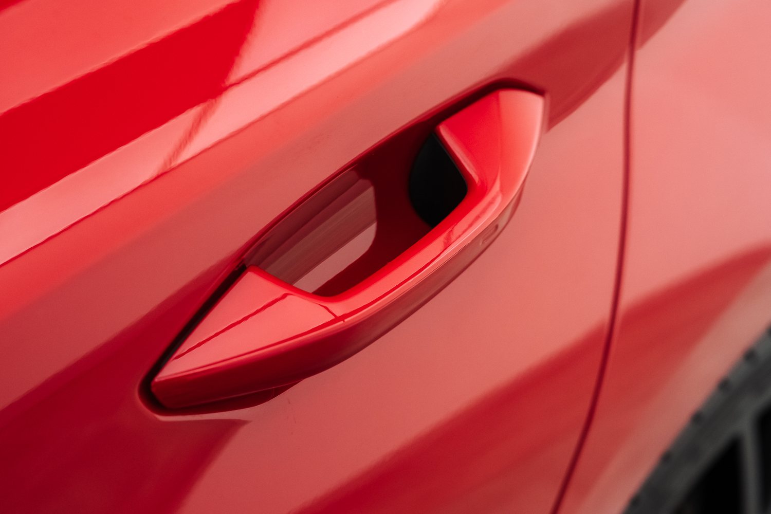 Door and mirror detail on a red Audi RS3