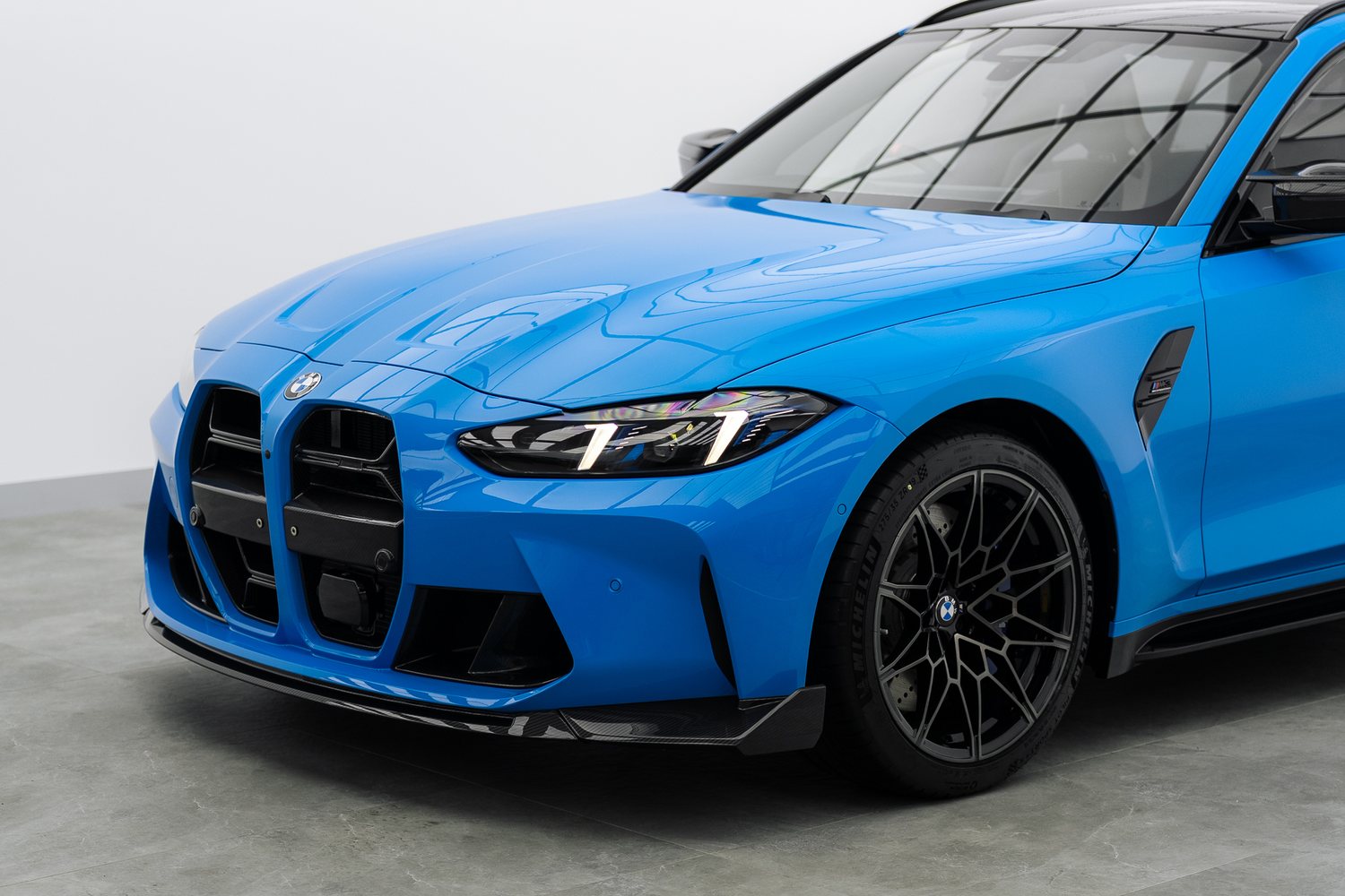 Front end of a blue BMW M3 Touring