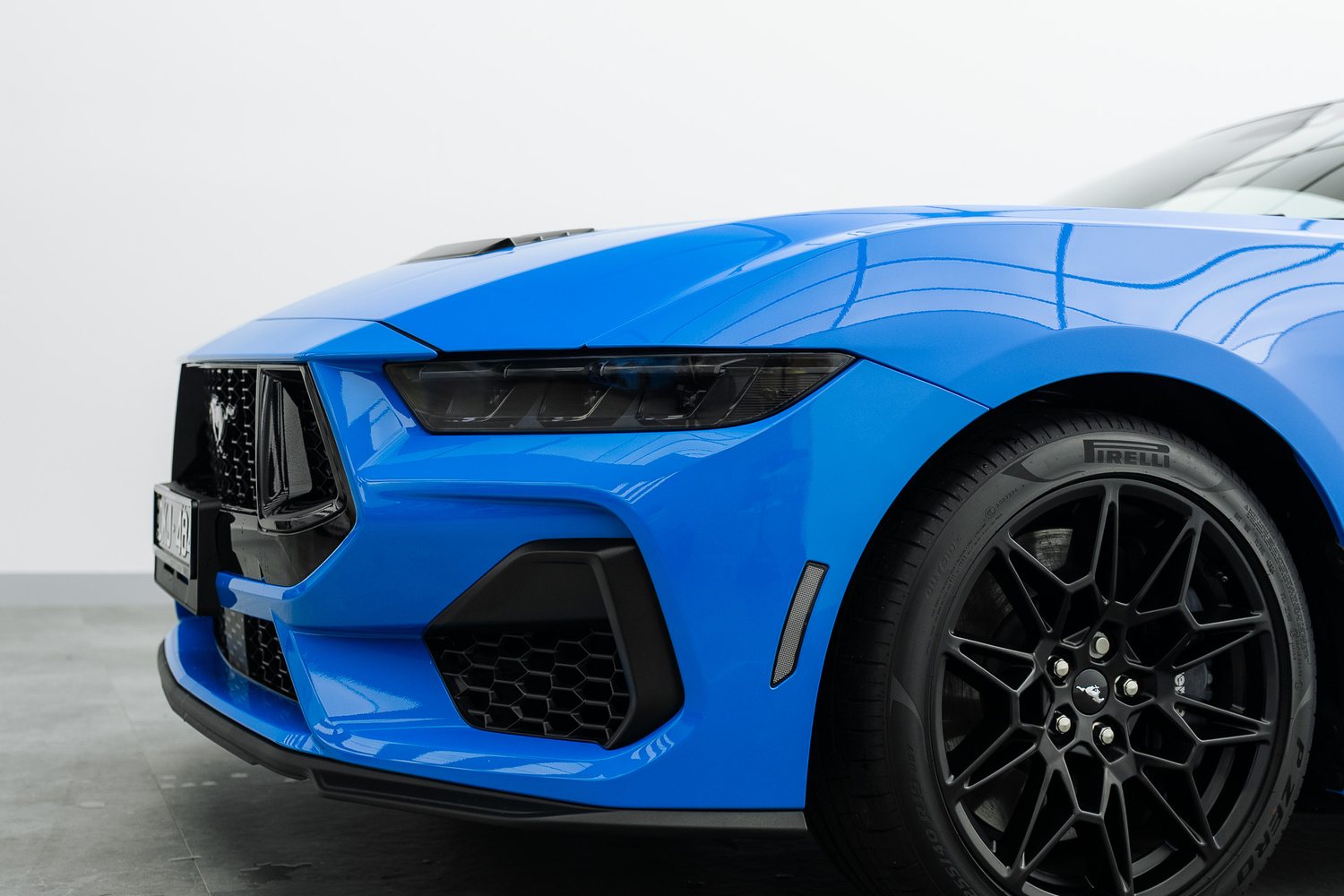 Front end of a blue Ford Mustang