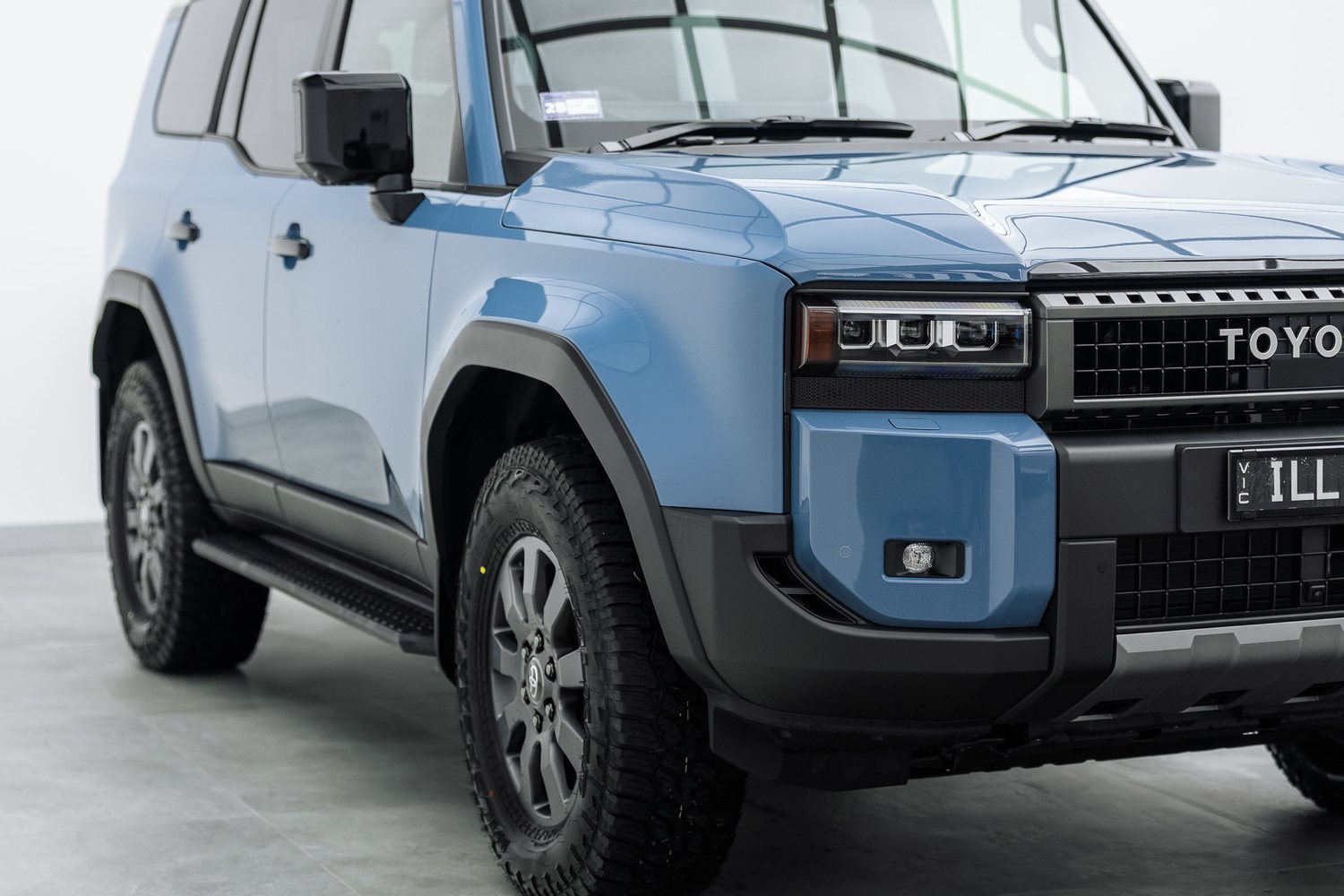 Front end of a blue Toyota LandCruiser Prado