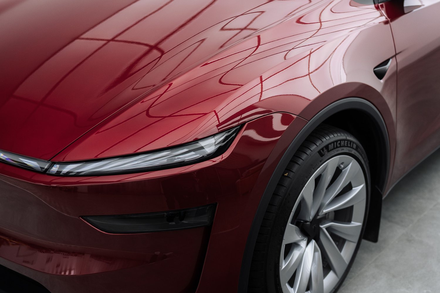 Front end of a red Tesla Model Y