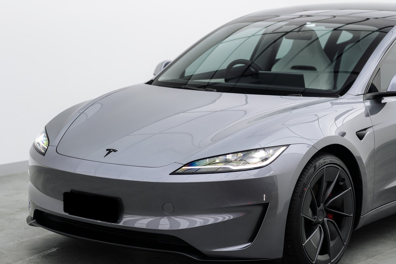 Front end of a silver Tesla Model 3