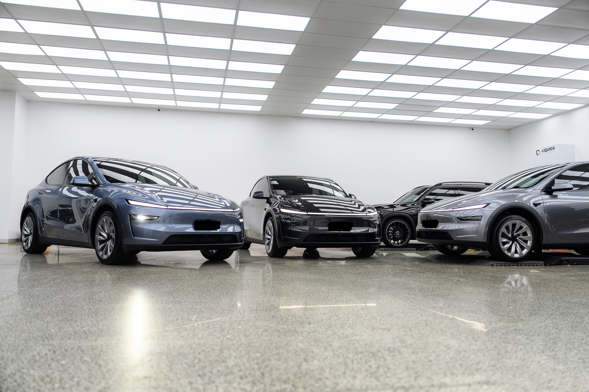 Three Teslas lined up in the Liquid R workshop