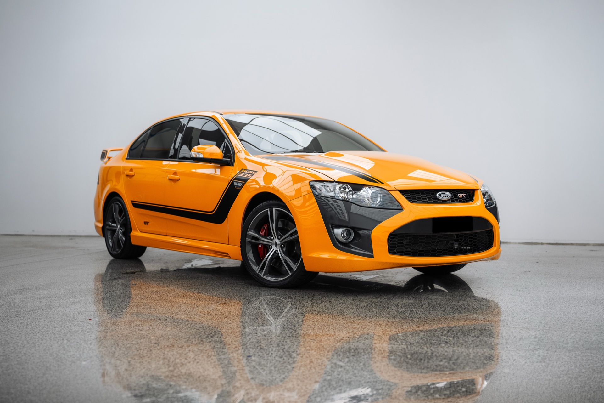 Orange FPV Ford Falcon in the Liquid R workshop