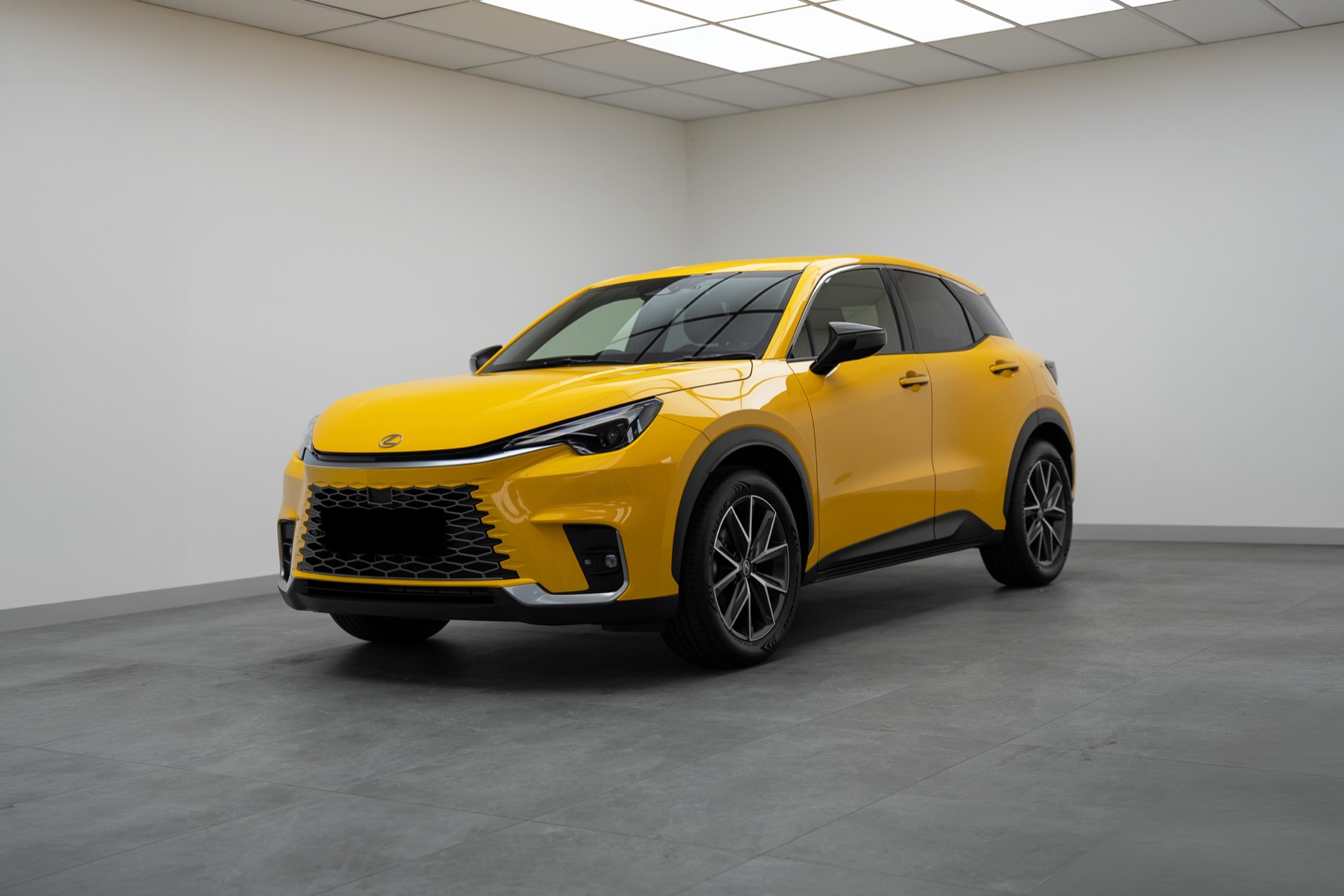 Yellow Lexus LBX hatchback in the Liquid R studio
