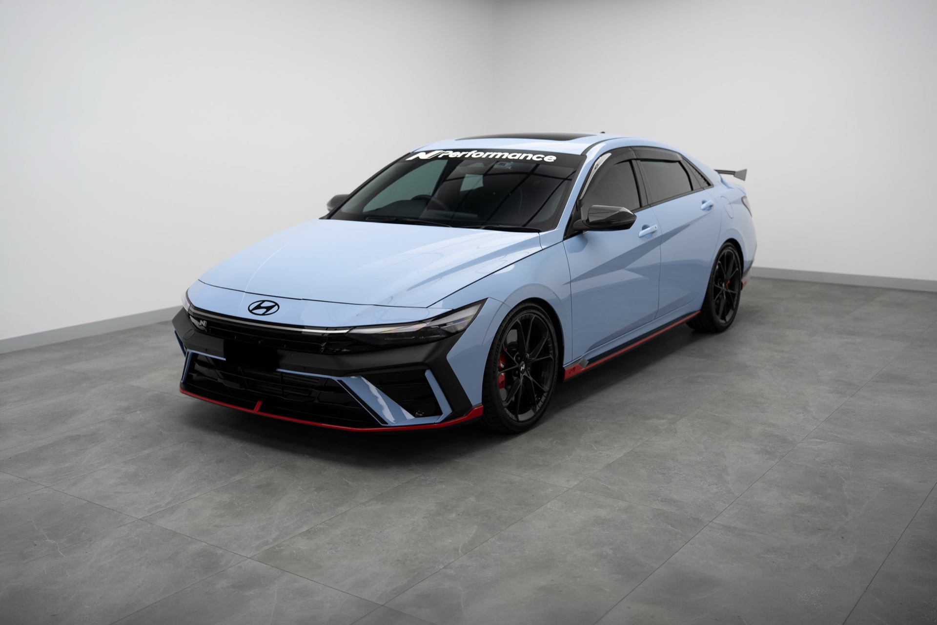 Light blue Hyundai i30 Sedan N in the Liquid R studio