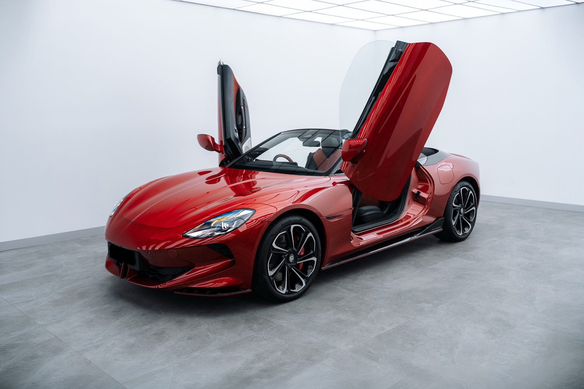 Red MG Cyberster with doors up in the Liquid R studio