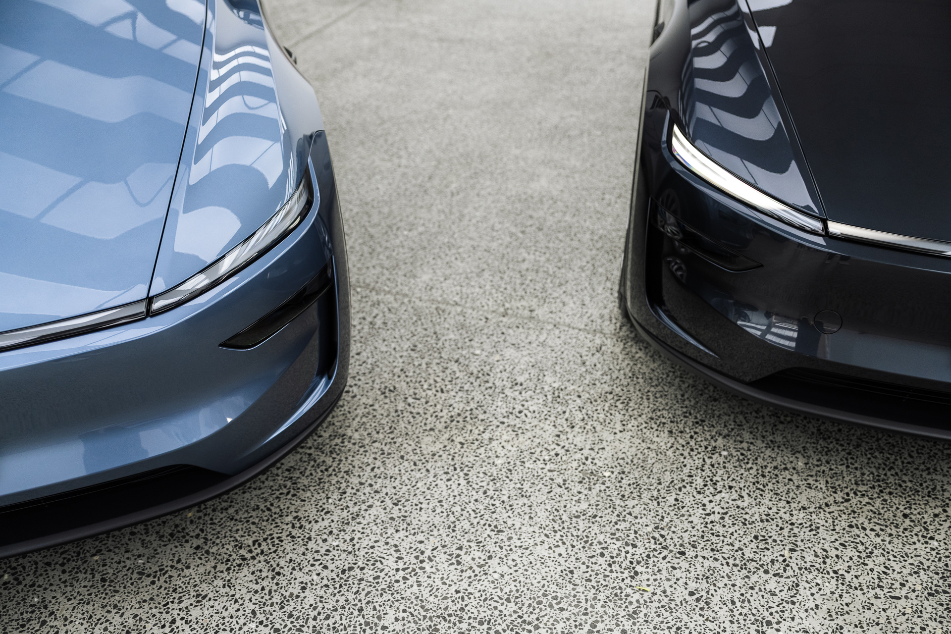 Front corners of two Teslas in the Liquid R workshop