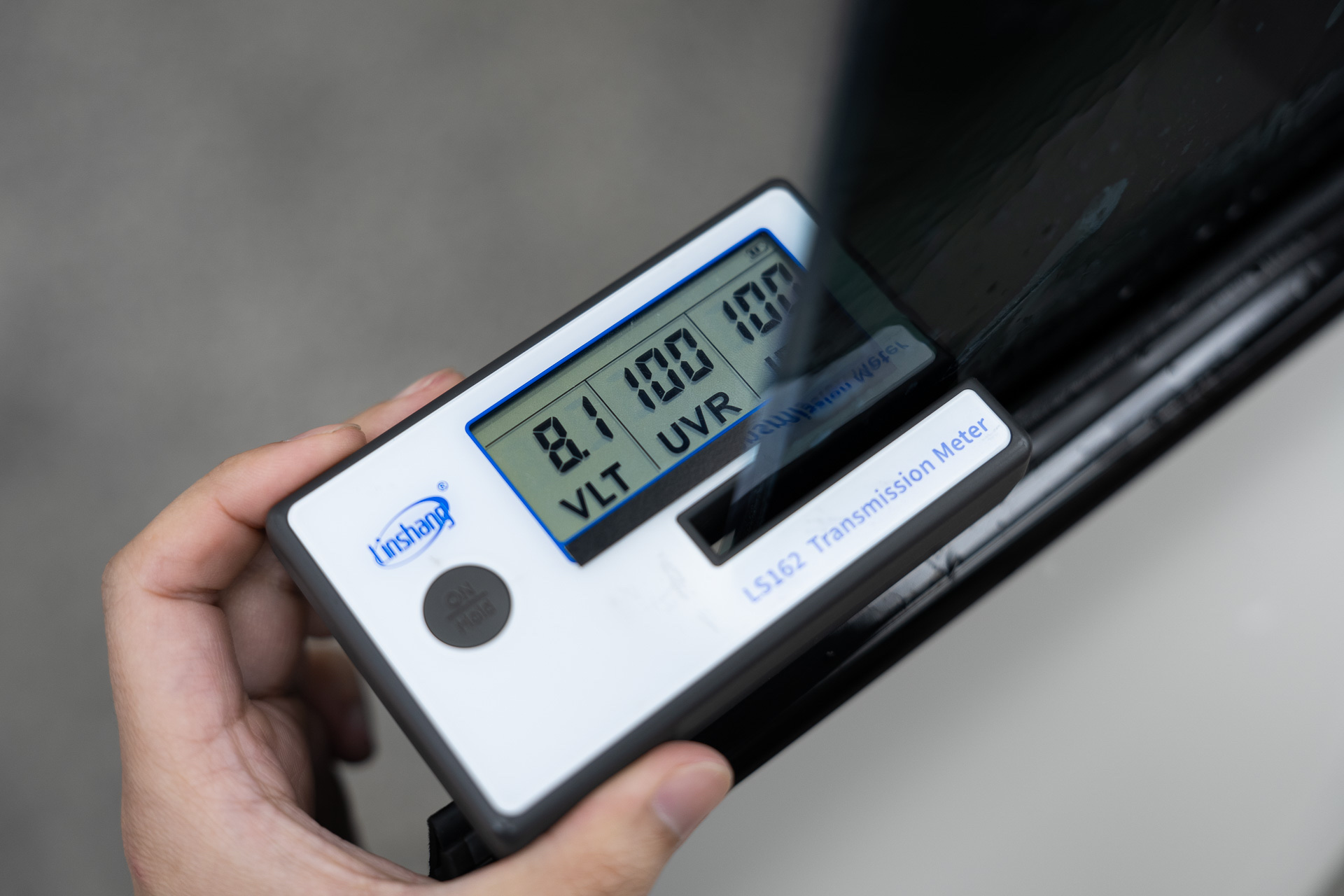 Tint meter reading VLT on a tinted window
