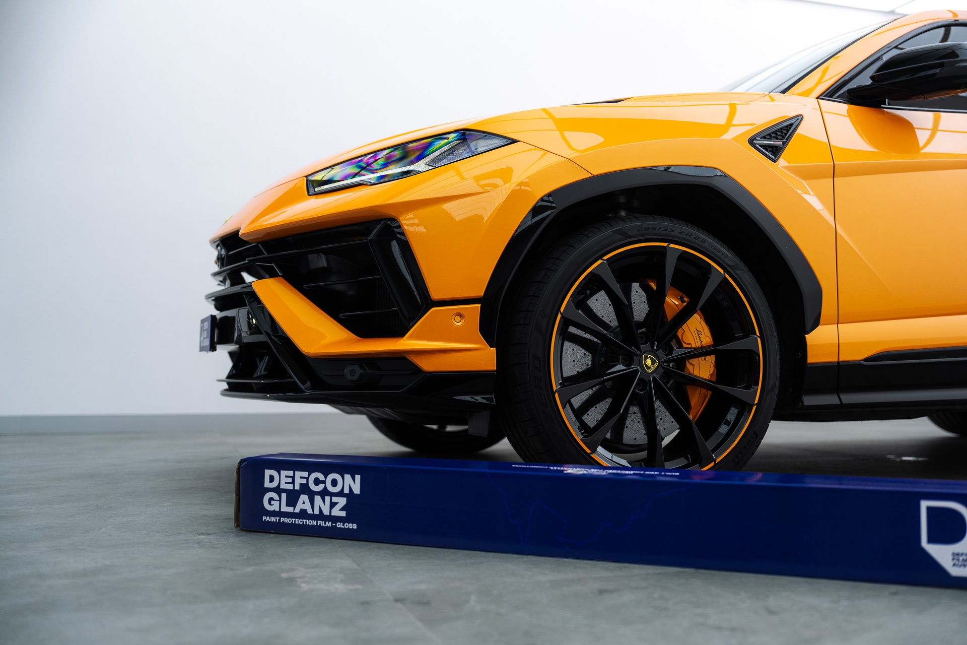 Orange Lamborghini Urus with Defcon Glanz film roll