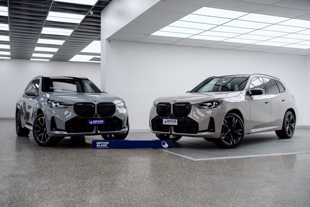 Two BMW X series SUVs with Defcon Films Australia Glanz film rolls