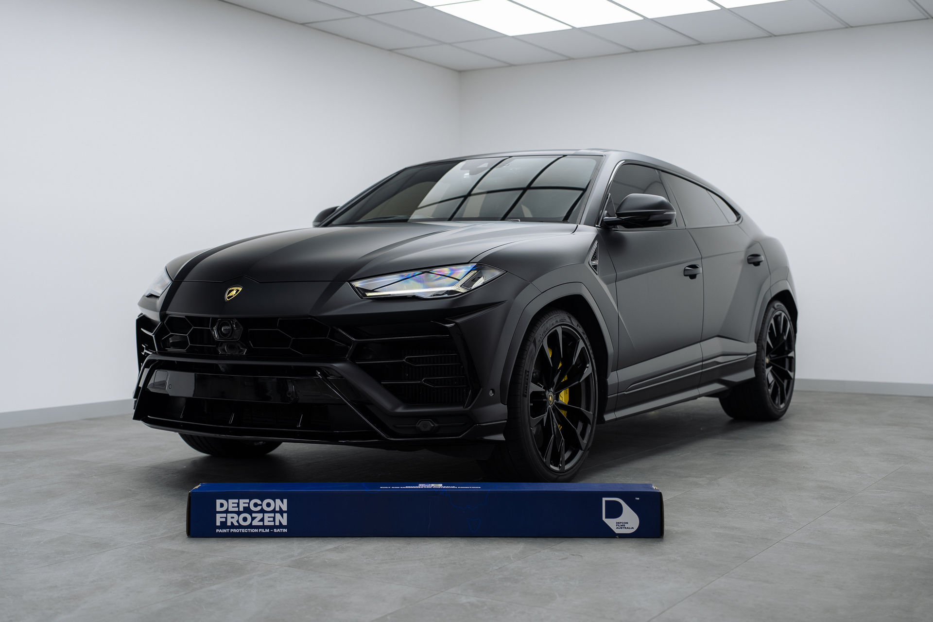 Matte black Lamborghini Urus with Defcon Frozen film roll