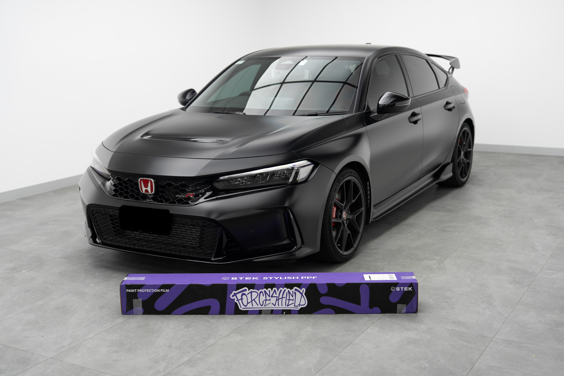 Black Honda Civic Type R with STEK film roll