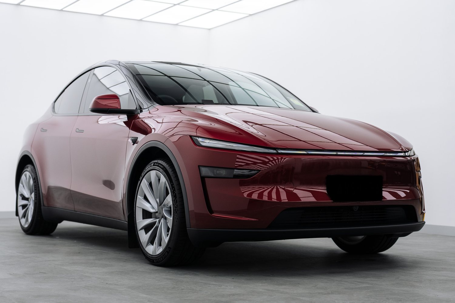 Red Tesla Model Y in the Liquid R studio