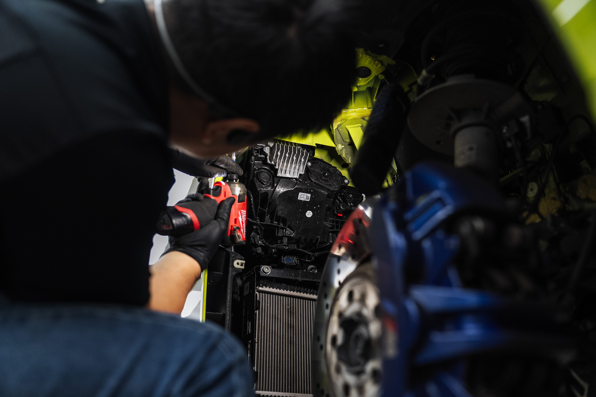 Mechanic working on a radiator and front end