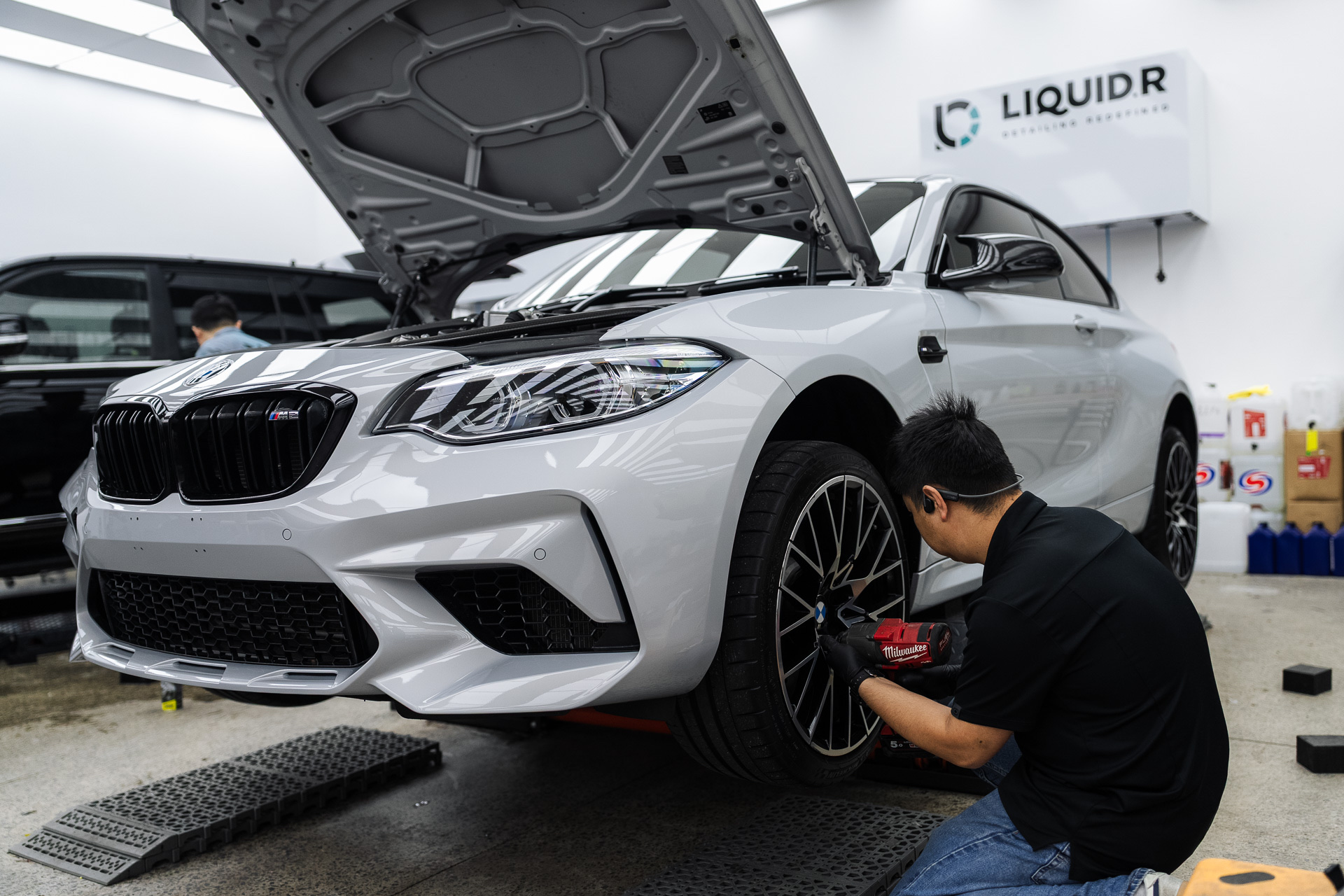 White BMW M2 on a hoist at the Liquid R workshop