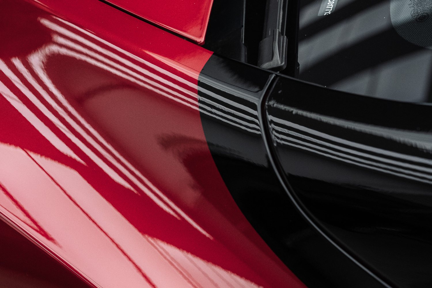 Side glass of a red Tesla Model Y