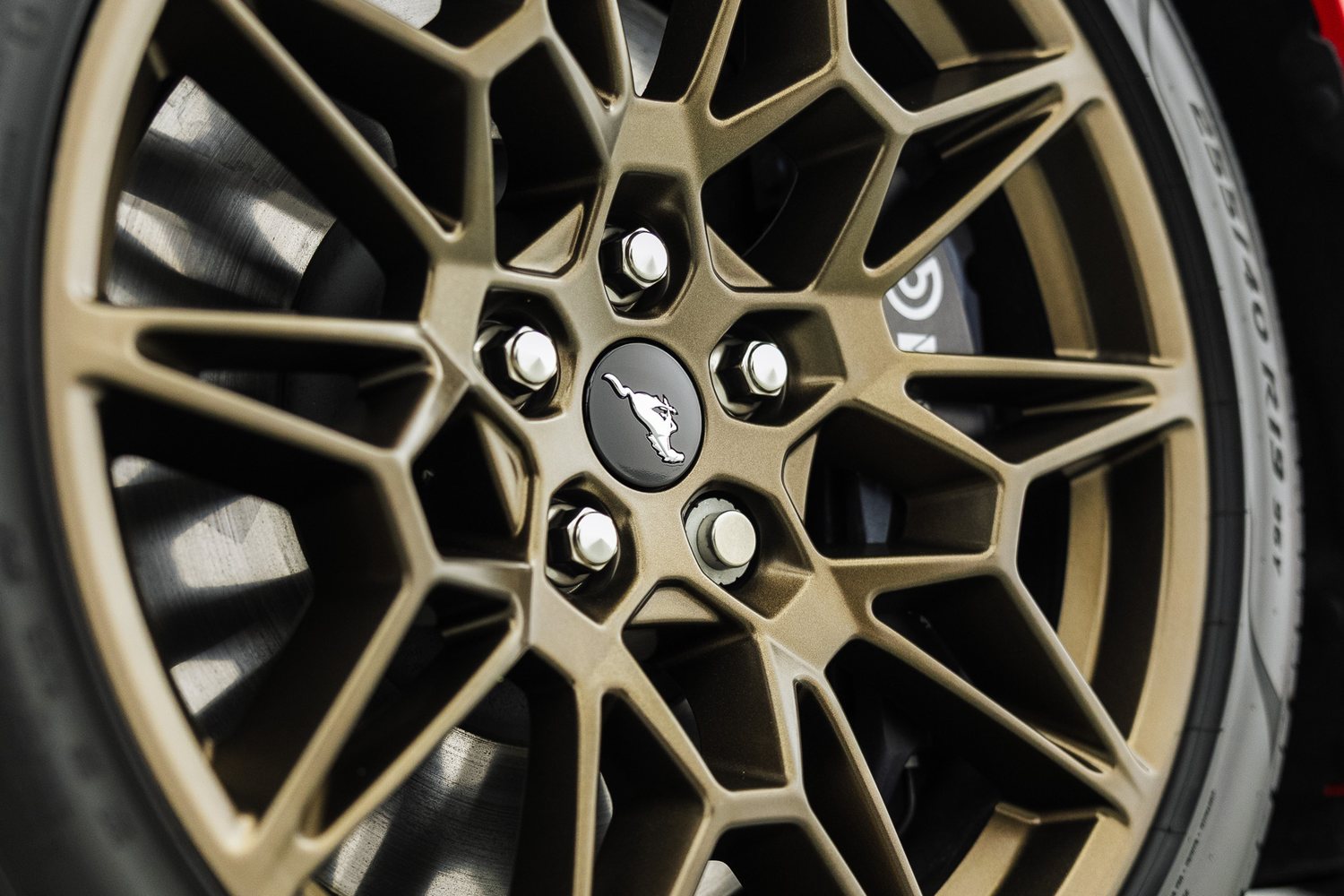 Wheel of a red Ford Mustang