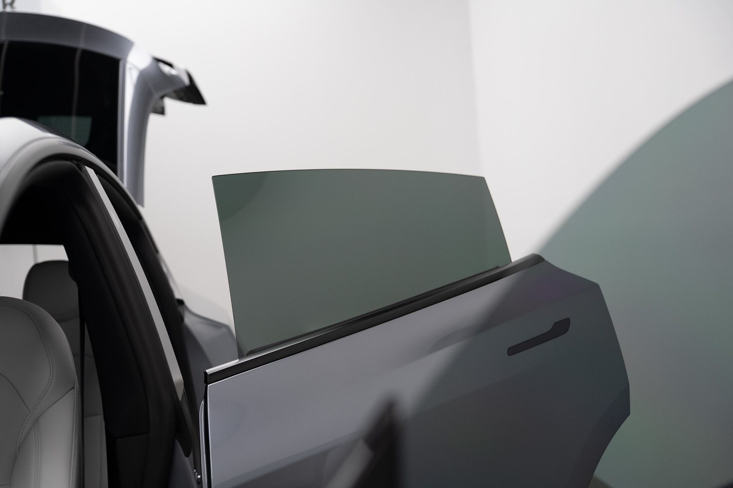 Window tint film being fitted to a car door