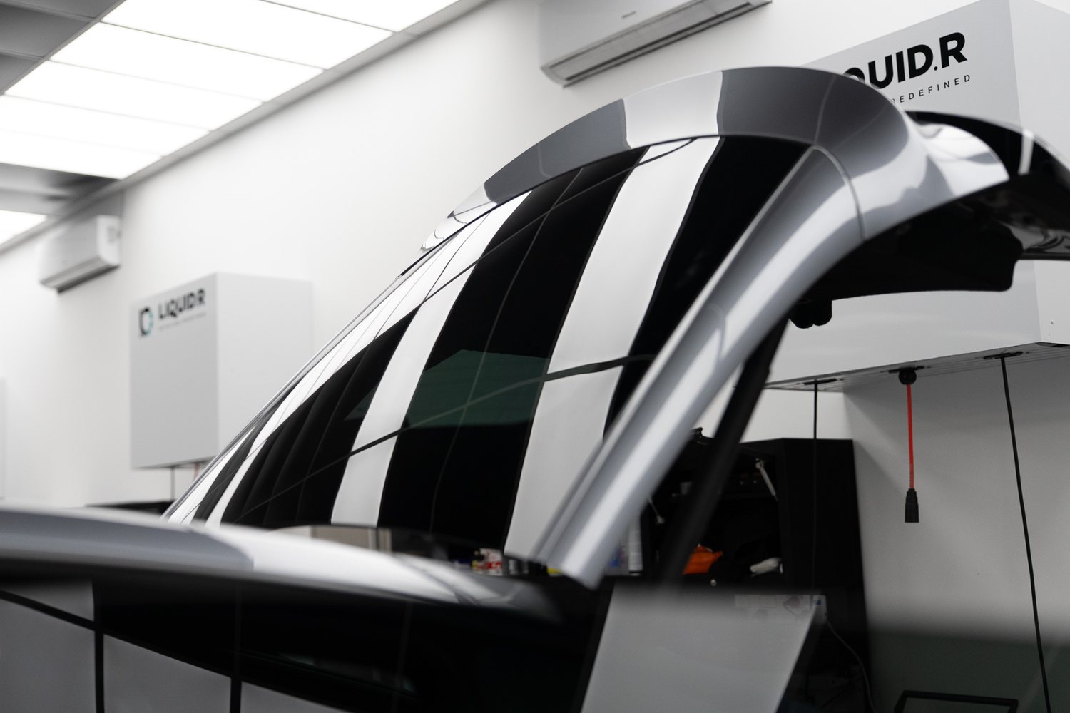 Window tint film being fitted to a car door
