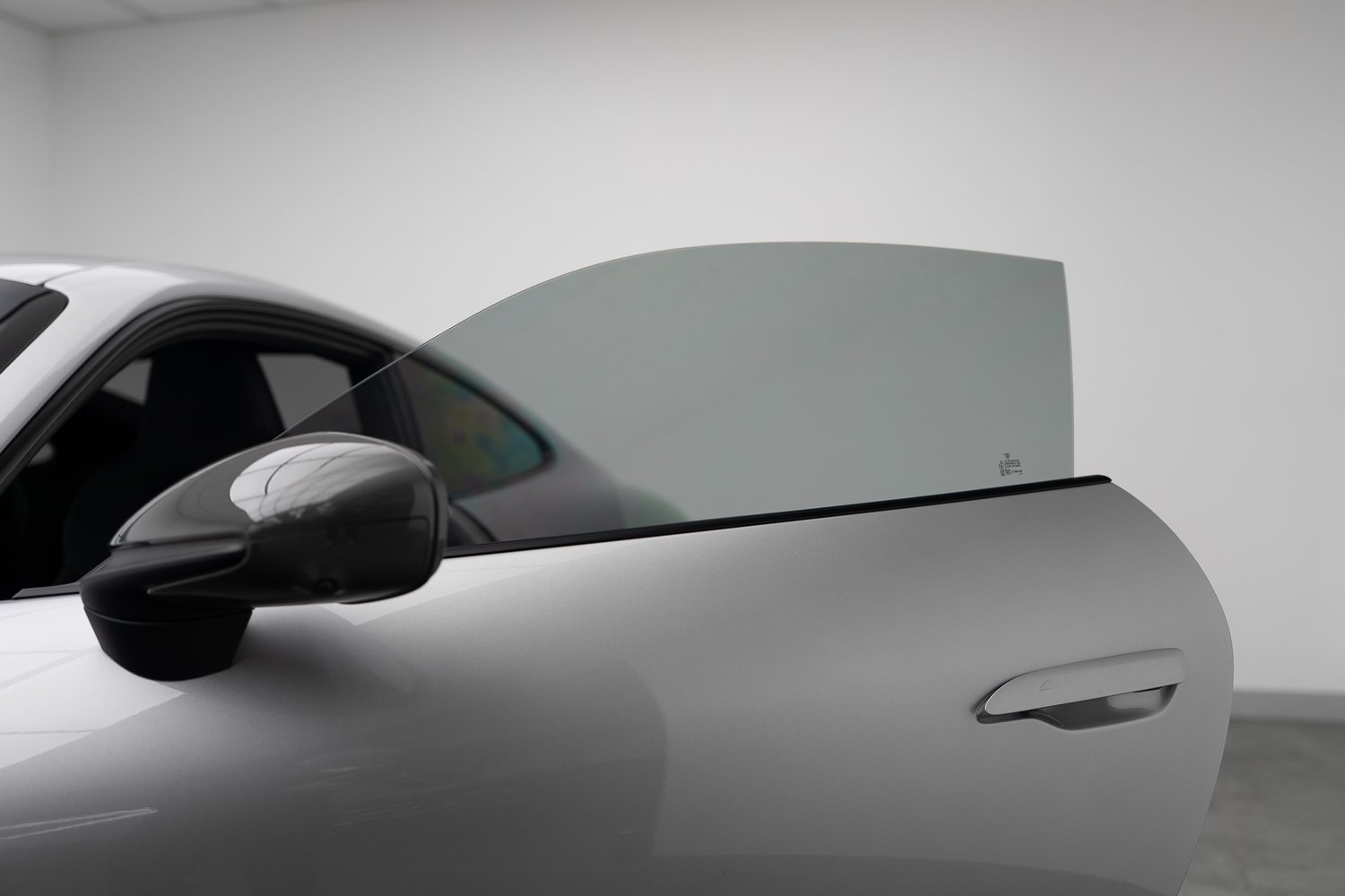 Window tint film being fitted to a car door