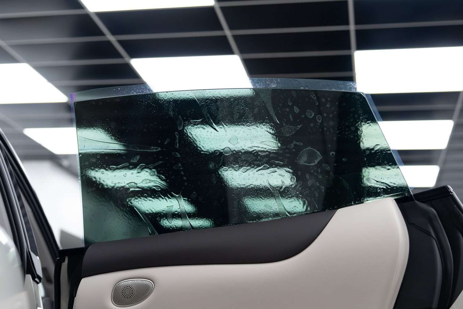 Window tint film being fitted to a car door